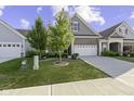 Gray and brick two-story home with white garage door at 17084 Cole Evans Dr, Noblesville, IN 46060