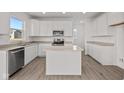 Modern kitchen with white cabinets, stainless steel appliances, and an island at 4168 Dutton Dr, Bargersville, IN 46106