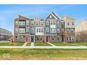Three-story townhouses with modern finishes and attached garages at 7284 County Road 600 W, McCordsville, IN 46055