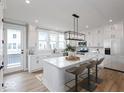 Modern kitchen with white cabinetry, quartz countertops, and island at 7284 County Road 600 W, McCordsville, IN 46055