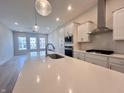 Modern kitchen with white cabinets, quartz countertops, and stainless steel appliances at 812 Templeton Dr, Carmel, IN 46032