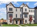 Modern 2-story townhome with gray siding, black windows, and a landscaped front yard at 4190 Douro Trl, Westfield, IN 46062