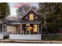 Enticing red house with white picket fence, illuminated at dusk at 617 E Mccarty St, Indianapolis, IN 46203