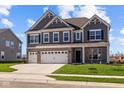 Two-story home with gray siding, white trim, and a three-car garage at 4988 Amber Crest Dr, Brownsburg, IN 46112