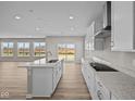 Modern kitchen with white cabinets, granite countertops, and stainless steel appliances at 4988 Amber Crest Dr, Brownsburg, IN 46112