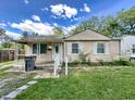 Front view of a charming beige ranch home with landscaping at 3438 N Leland Ave, Indianapolis, IN 46218