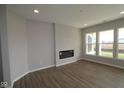 Living room with fireplace and hardwood floors at 16920 Cattle Hollow Ln, Noblesville, IN 46060