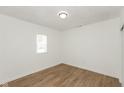 Bright bedroom with wood-look floors and a spacious closet at 728 E Beecher St, Indianapolis, IN 46203