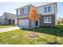 Two-story brick home with gray accents and an attached garage at 168 Velvet Hat Rd, Danville, IN 46122