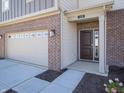 Brick home's front entry with a dark brown door and attached garage at 168 Velvet Hat Rd, Danville, IN 46122