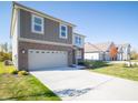 Two-story brick home with gray accents and attached two-car garage at 168 Velvet Hat Rd, Danville, IN 46122