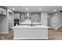 Modern kitchen with gray cabinets, quartz countertops, and stainless steel appliances at 4959 Amber Crest Dr, Brownsburg, IN 46112