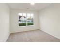 Bright bedroom with neutral walls and carpet, featuring a large window at 134 Maxim Ct, Cumberland, IN 46229