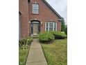 Brick home with a well-maintained lawn and walkway at 10870 Picket Fence Pl, Fishers, IN 46037