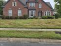 Two-story brick home with a spacious front yard at 10870 Picket Fence Pl, Fishers, IN 46037
