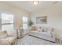 Cozy living room featuring a comfy sofa and large windows at 3923 Windstar Way, Columbus, IN 47203
