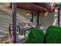 Inviting front porch with seating and lush landscaping at 7932 Eagle Valley Pass, Indianapolis, IN 46214