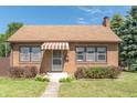 Brick house with brown awning, landscaping, and walkway at 532 E Mills Ave, Indianapolis, IN 46227