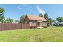 Brick house with brown awning, landscaping, and walkway at 532 E Mills Ave, Indianapolis, IN 46227