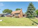 Brick house with brown awning, landscaping, and walkway at 532 E Mills Ave, Indianapolis, IN 46227