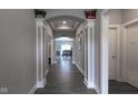 Gray hallway with dark flooring and arched entryways at 6611 Ventnor Pl, Indianapolis, IN 46217