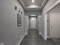Bright entry hall with gray walls, hardwood floors, and white trim at 6611 Ventnor Pl, Indianapolis, IN 46217