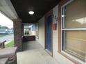 Front porch with brick columns and a blue door at 305 Leeds Ave, Indianapolis, IN 46201