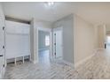 Bright entryway with built-in bench, storage, and hardwood floors at 2841 Grandview Ln, Greenwood, IN 46143