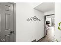 Clean hallway with gray walls and a decorative metal wall hanging at 9644 Highgate N Cir, Indianapolis, IN 46250
