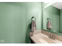 Small bathroom with a granite countertop and sage green walls at 9644 Highgate N Cir, Indianapolis, IN 46250