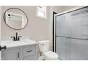 Updated bathroom with gray vanity, black fixtures, and shower at 2729 Massachusetts Ave, Indianapolis, IN 46218