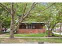 Brick house with front porch and large trees at 3860 N Delaware St, Indianapolis, IN 46205