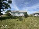 Rear view of the house, showcasing a large yard at 1452 E Sr 234, Greenfield, IN 46140