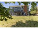 Large backyard with deck and lush green grass at 9259 Oak Knoll Ln, Fishers, IN 46037