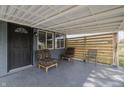 Covered patio with two chairs and a wooden privacy screen at 3730 Prospect St, Indianapolis, IN 46203