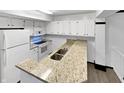 Bright kitchen featuring granite countertops and white cabinets at 3213 Oceanline E Dr, Indianapolis, IN 46214