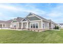 Exterior view of a home with green siding, white trim, and a covered entryway at 6210 Fairview Dr, McCordsville, IN 46055