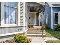 Inviting front porch with potted plants and steps at 1715 Alabama St, Indianapolis, IN 46202
