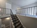Staircase with black metal railing leading to the living room at 4050 Byram Ave, Indianapolis, IN 46208
