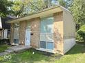 Brick ranch home with a white door and small front yard at 4050 Byram Ave, Indianapolis, IN 46208