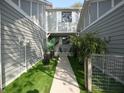 Private townhouse entry with artificial turf and potted plants at 7419 Sylvan Ridge Rd, Indianapolis, IN 46240