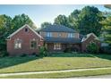 Brick and siding two story house with a large front yard at 6403 Quail Creek Blvd, Indianapolis, IN 46237