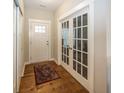 Bright entryway with hardwood floors, featuring a coat closet and French doors at 1569 Tupelo Dr, Greenfield, IN 46140