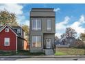 Contemporary three-story home with gray siding and a welcoming entrance at 417 E Morris St, Indianapolis, IN 46225