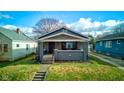 Gray house with brick details, front porch, and landscaped yard at 385 S Arlington Ave, Indianapolis, IN 46219