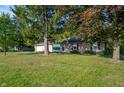 House exterior showcasing stone facade, landscaping, and a spacious lawn at 2623 S Central Way, Anderson, IN 46011