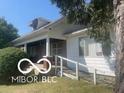 Ranch style home with a covered porch and attached ramp at 1108 Burdsal Pkwy, Indianapolis, IN 46208
