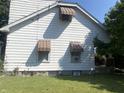 White sided home with brown awnings and a well maintained lawn at 1108 Burdsal Pkwy, Indianapolis, IN 46208