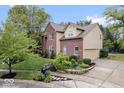 Two-story house with brick and siding, landscaped yard, and attached garage at 8418 Mesic Ct, Indianapolis, IN 46278