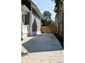 Long concrete driveway with wooden fence and landscaping at 3131 Boulevard Pl, Indianapolis, IN 46208